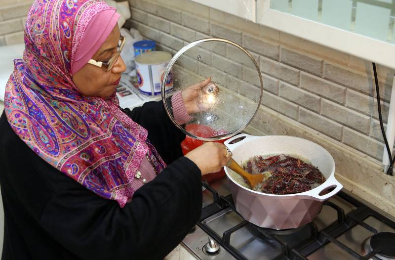 Moudi al-Miftah, a 64-year-old journalist, cooks locust at her home in Al-Ahmadi, some 35 kilometres south of Kuwait City
