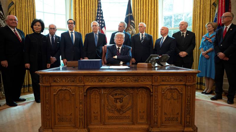 Trump signs $2 trillion recovery plan as US virus cases skyrocket