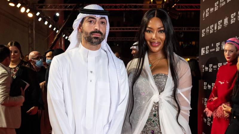 Red Sea Festival shows (L to R) Red Sea Film Festival chairman Mohamed Turki posing with British model Naomi Campbell on the red carpet of the closing ceremony of the first edition of the festival