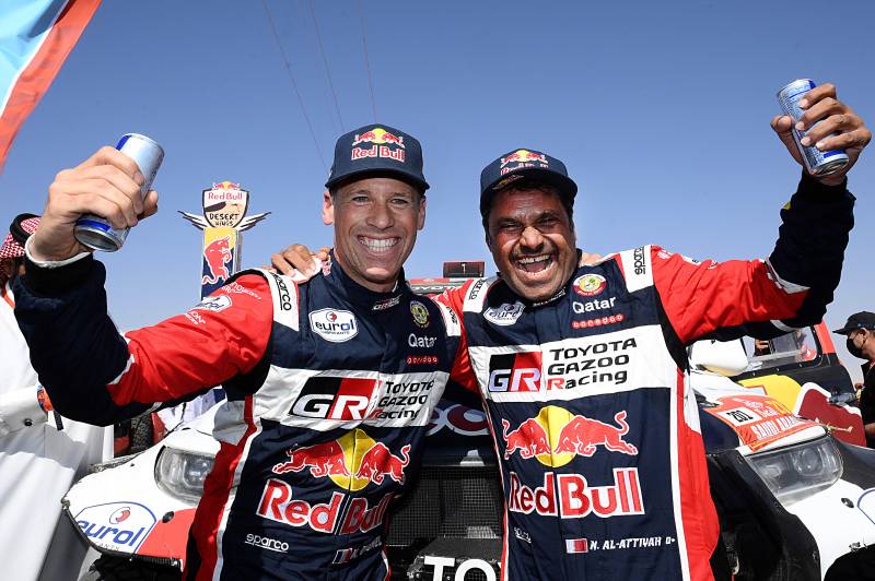 Toyota's driver Nasser al-Attiyah of Qatar (R) and his co-driver Matthieu Baumel of France celebrates their victory after winning the Dakar Rally 2022, at the end of the last stage between Bisha and Jeddah in Saudi Arabia. AFP