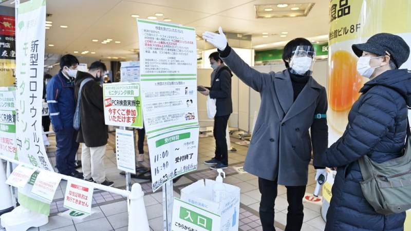 Japan brings back virus restrictions over Omicron surge