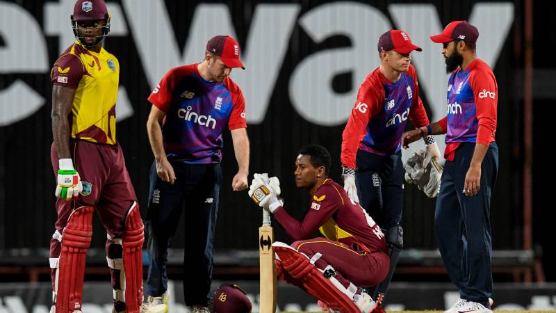 Liam Dawson (2L), Sam Billings (2R) and Adil Rashid (R) of England console Akeal Hosein (C) and Romario Shepherd (L) of West Indies while they express disappointment after losing the 2nd T20I between West Indies and England at Kensington Oval. AFP