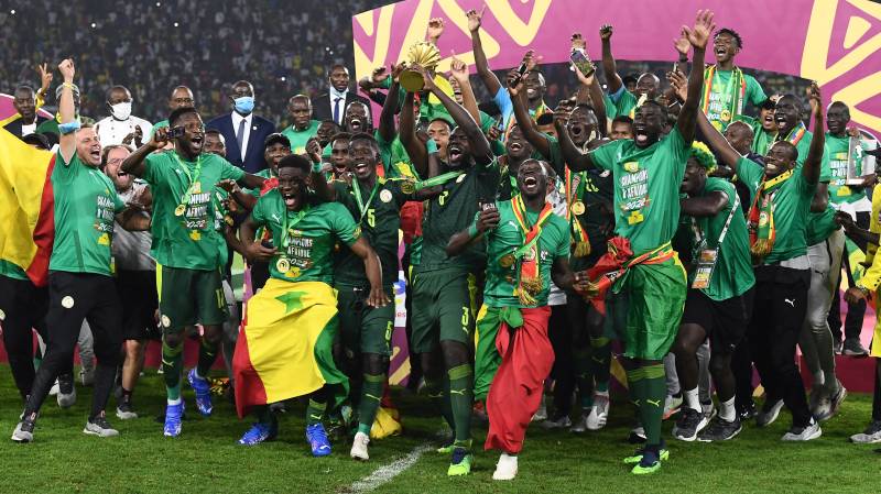 Senegal's players celebrate with the trophy after winning the Africa Cup of Nations (CAN) 2021 final football match between Senegal and Egypt at Stade d'Olembe in Yaounde. AFP