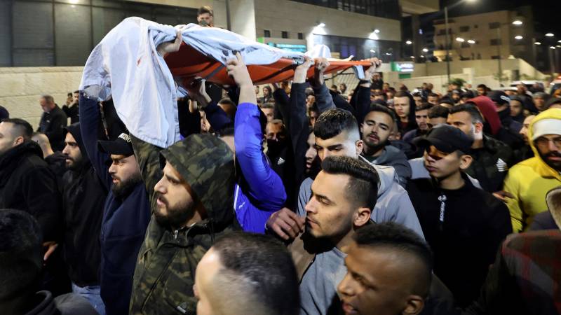 Palestinians carry the body of Mohamad Saleh, 17, after he was killed during clashes with Israeli forces in the occupied West Bank village Al Yamun, near Jenin, Palestinian territories on February 14, 2022. AFP