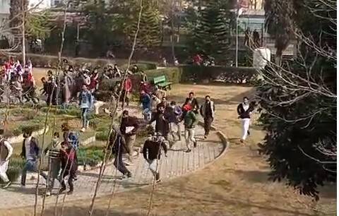 Students run for cover as the police move in.