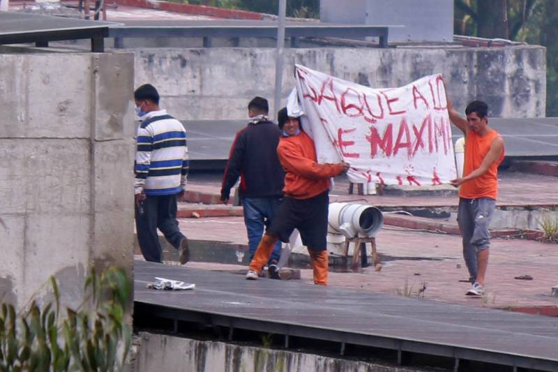 Inmates are seen on the roof of the CRS Turi prison after a riot in Cuenca, Ecuador. AFP