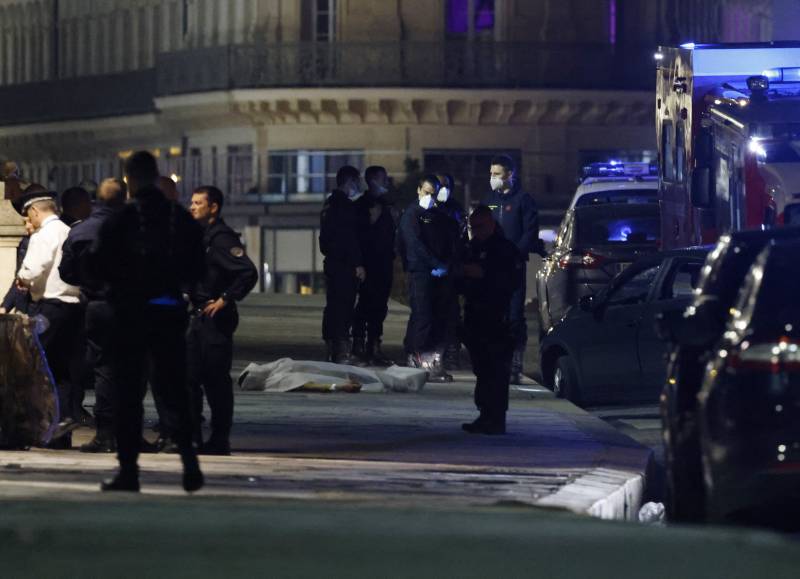 Police investigate the site of a shooting where two people were shot by police in Paris. AFP