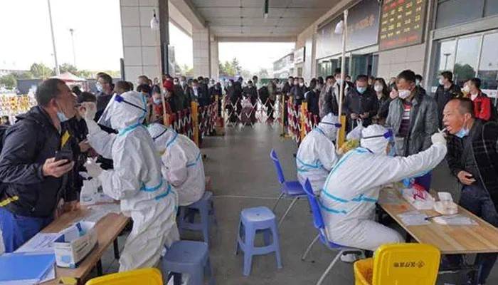 China megacity mass-tests, cancels flights after suspected Covid case