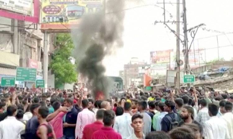 Indian protesters burn trains over military jobs plan