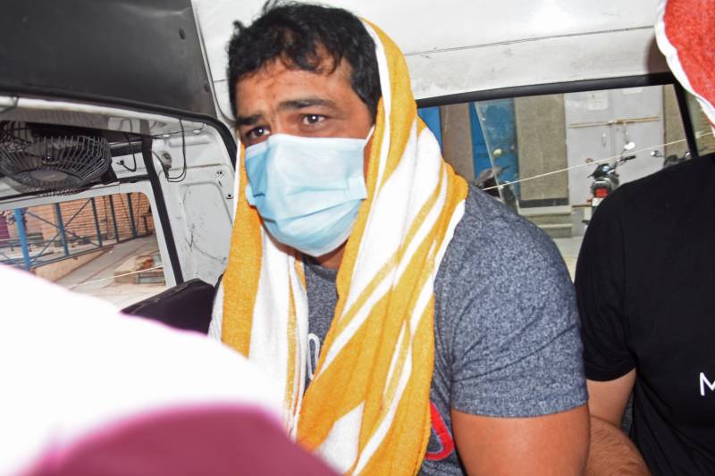 In this file photo taken on May 23, 2021, police transport India's Olympic medallist wrestler Sushil Kumar in a vehicle after arresting him over alleged involvement in the murder of a fellow wrestler in New Delhi. AFP