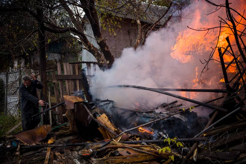 A local resident works to extinguish a fire after shelling in the town of Bakhmut, in eastern Ukraine's Donbas region. AFP