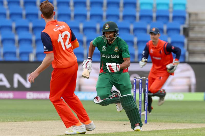Bangladesh's Najmul Hossain Shanto (C) runs between the wickets on the first ball of the innings during the ICC men's Twenty20 World Cup match between Bangladesh and Netherlands at Bellerive Oval in Hobart. AFP