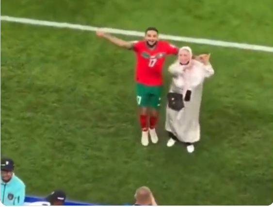 Footballer Sofiane Boufal celebrating Morocco's win with his mother on pitch