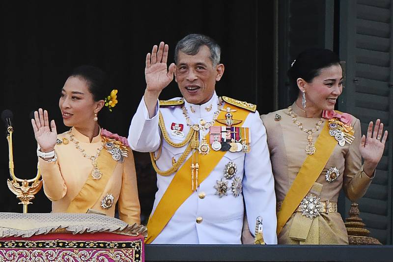 In this file photo taken on May 6, 2019, Thailand's King Maha Vajiralongkorn (C), Queen Suthida and his daughter Princess Bajrakitiyabha Mahidol (L) wave to well-wishers from the balcony of Suddhaisavarya Prasad Hall of the Grand Palace. AFP