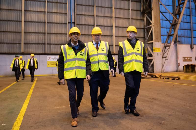 (From L) Britain's Prime Minister Rishi Sunak, Harland & Wolff CEO John Wood, and Britain's Northern Ireland Secretary Chris Heaton-Harris visit the Harland & Wolff shipyard factory in Belfast, Northern Ireland. AFP