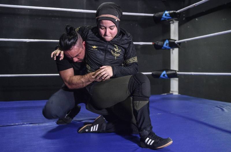 Hijab-wearing woman rises above male-dominated Malaysian wrestling