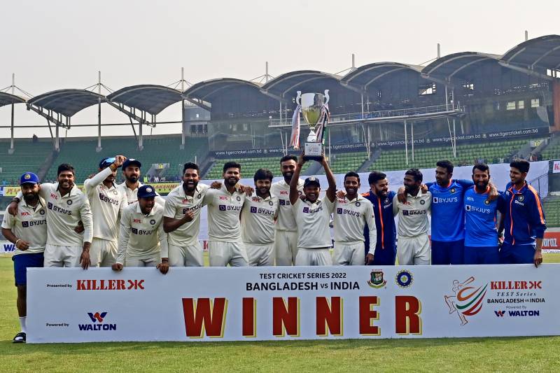 India’s cricketers pose for a photo as they hold the tournament trophy after winning on the fourth day of the second cricket Test match between Bangladesh and India at the Sher-e-Bangla National Cricket Stadium in Dhaka on December 25, 2022. AFP 
