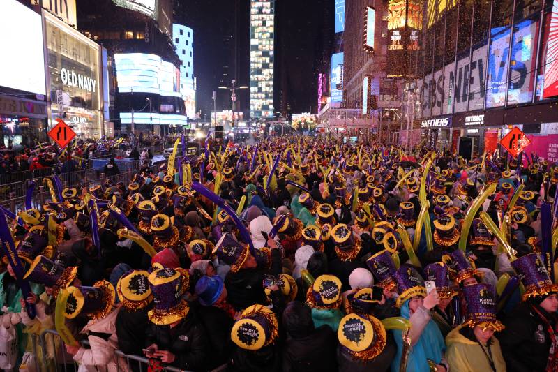 People gather to celebrate the New Year and await the ball drop, in Times Square, New York City, on December 31, 2022. AFP