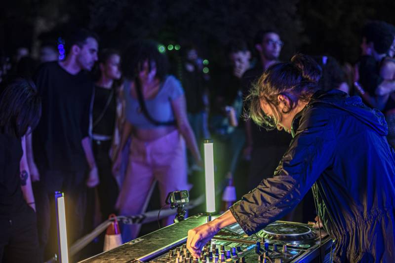 Egyptian DJ A7ba-L-Jelly plays music during a concert in Giza on November 4, 2022. AFP 