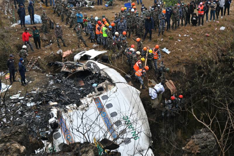 Rescuers pull the body of a victim who died in a Yeti Airlines plane crash in Pokhara. AFP