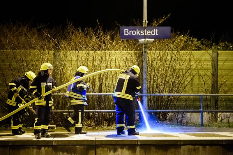 Firefighters of a local fire department clean the platform at the train station in Brokstedt, northern Germany, after two people were killed and several others wounded in a knife attack on a regional train between the cities of Hamburg and Kiel. AFP