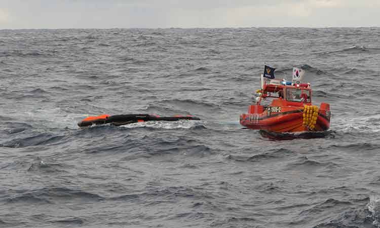 South Korea coast guard vessel searches for the missing crew men.
