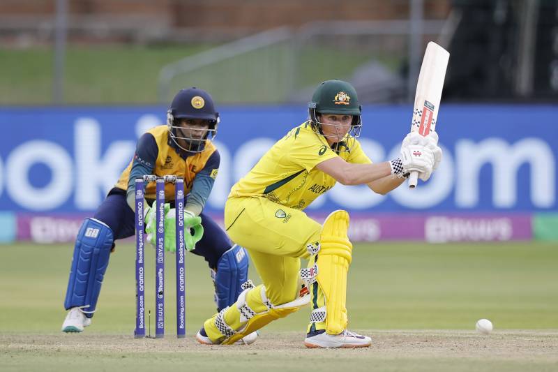 Australia's Beth Mooney (R) plays a shot as Sri Lanka's wicketkeeper Anushka Sanjeewani (L) looks on during the Group A T20 women's World Cup cricket match between Sri Lanka and Australia. AFP