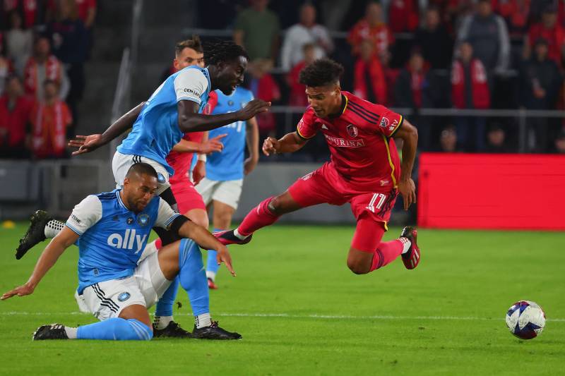 Nicholas Gioacchini #11 of St. Louis City falls over Bill Tuiloma #6 of Charlotte FC in the first half at Citypark on March 4, 2023 in St Louis, Missouri. AFP 