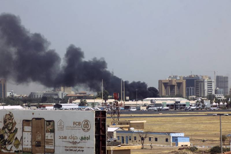 Heavy smoke bellows above buildings in the vicinity of the Khartoum's airport on April 15, 2023, amid clashes in the Sudanese capital. AFP