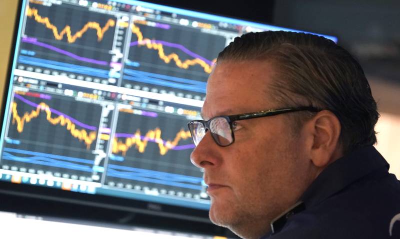 A trader on the floor at the New York Stock Exchange (NYSE) in New York during the opening bell on April 17, 2023. Stock markets traded mixed Monday over concerns that central banks may have to wait longer than expected to end their policy of raising interest rates. AFP