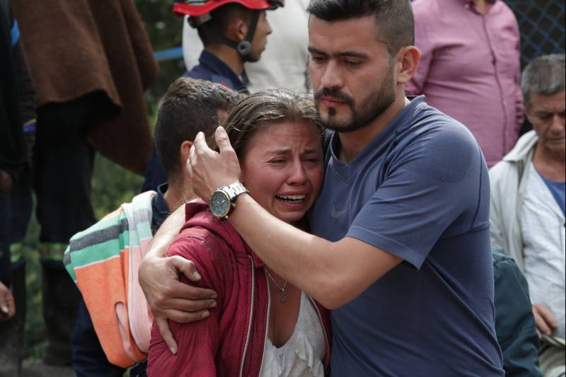 Relatives of a miner trapped inside a coal mine react after learning that their loved one was found dead in Cucunuba, Colombia, on April 20, 2023. Three people were killed and four others are missing in a coal mine in central Colombia after an explosion in two interconnected shafts, authorities said Thursday. AFP 