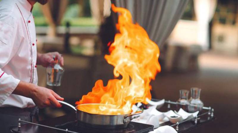 Two people died and ten were injured in a fire sparked when a waiter at a Madrid restaurant flambeed a dish.