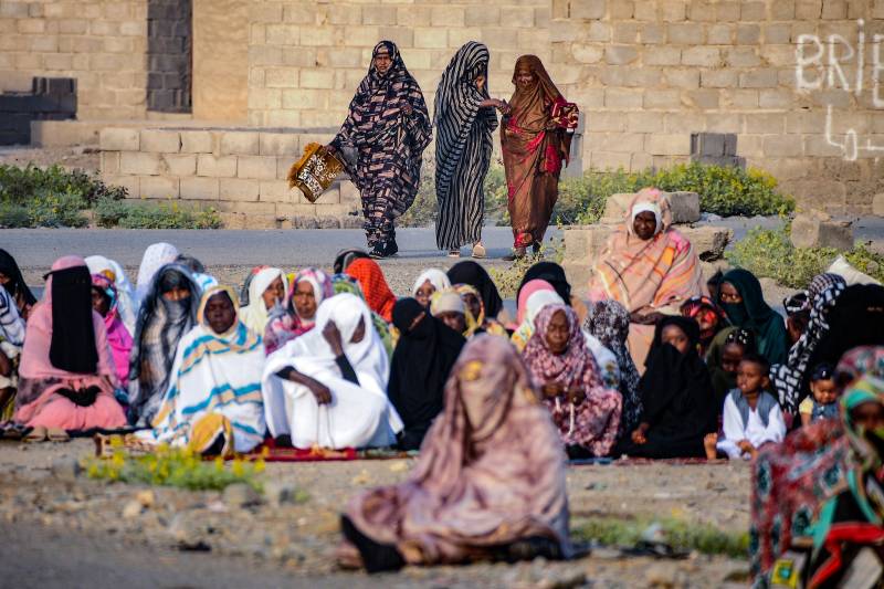 Women gather to pray in Port Sudan, on the first day of Eid al-Fitr, which marks the end of the Muslim fasting month of Ramadan, on April 21, 2023. Hundreds of people have been killed and thousands wounded since the fighting erupted on April 15 between forces loyal to Sudan's army chief and the commander of the powerful paramilitary Rapid Support Forces (RSF). AFP