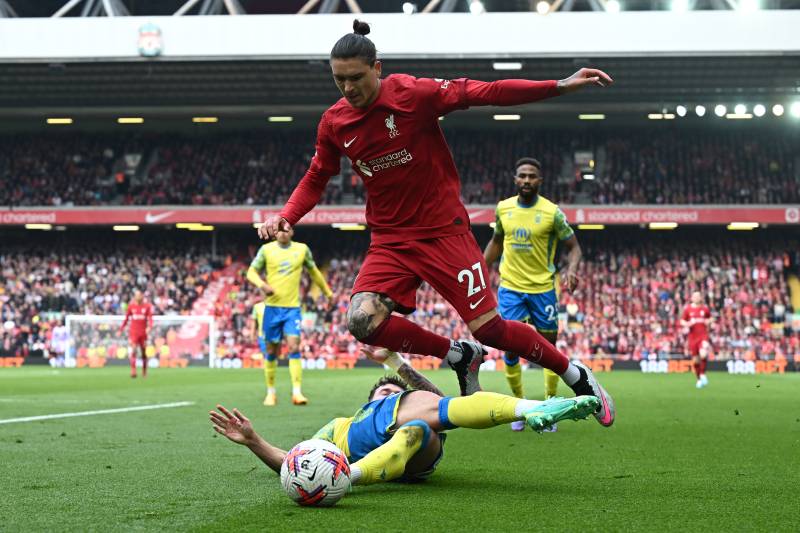 Nottingham Forest's Welsh defender Neco Williams tackles Liverpool's Uruguayan striker Darwin Nunez (up) during the English Premier League football match between Liverpool and Nottingham Forest at Anfield in Liverpool, north west England on April 22, 2023. AFP