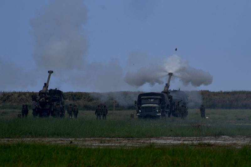 Philippine soldiers fire 155 mm Howitzers during a live fire exercise as part of the US-Philippines Balikatan joint exercise at the naval training base in San Antonio, Zambales province. AFP