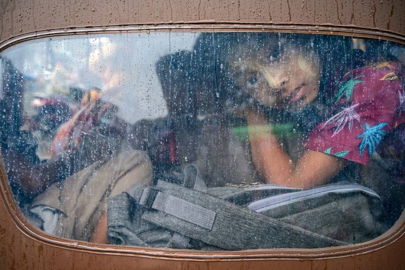 A girl looks out from a tuk tuk while evacuating in Sittwe in Myanmar’s Rakhine state on May 13, 2023, ahead of the arrival of Cyclone Mocha. AFP 