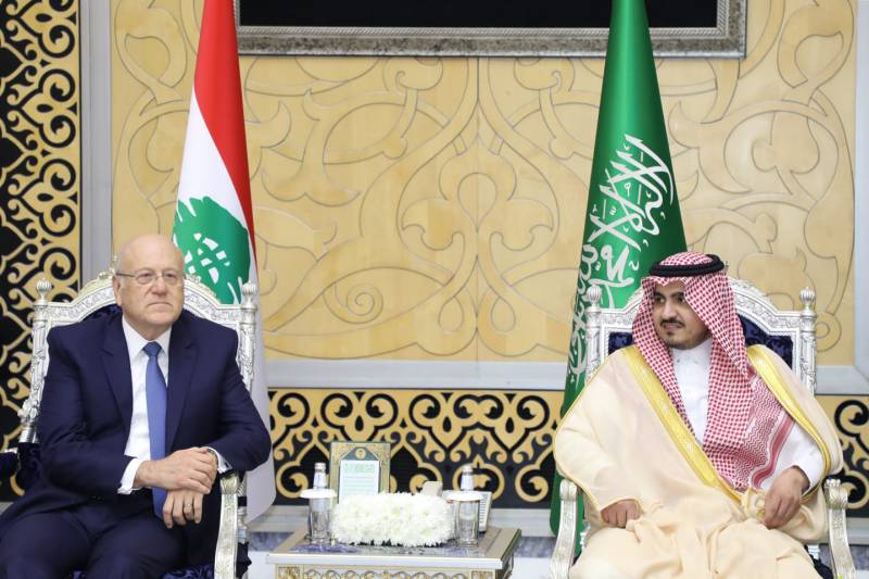 A handout picture provided by the Lebanese photo agency Dalati and Nohra on May 18, 2023 shows Deputy Emir of Mecca Prince Badr bin Sultan bin Abdulaziz (R) welcoming Lebanese caretaker Prime Minister Najib Mikati upon his arrival in Jeddah, on the eve of the Arab League summit. AFP 