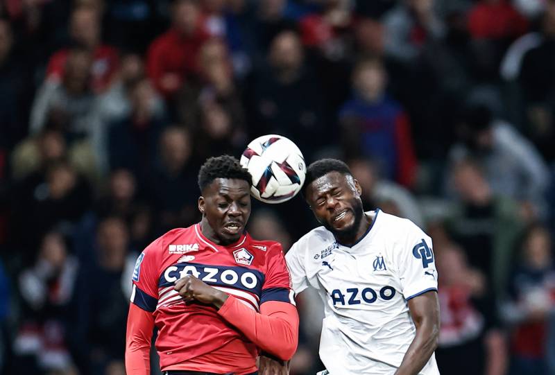 Lille's Franco-Guinean forward Mohamed Bayo (L) and Marseille's Congolese defender Chancel Mbemba jump to head the ball during the French L1 football match between Lille LOSC and Olympique Marseille (OM) at the Pierre-Mauroy stadium in Villeneuve-d'Ascq, northern France, on May 20, 2023. (Photo by Sameer Al-DOUMY / AFP