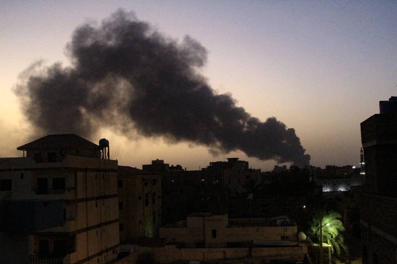 Smoke rises above buildings in southern Khartoum on May 19, 2023, as violence between two rival Sudanese generals continues. About half a million people have fled Khartoum since fighting broke out in mid-April with shelling and air strikes continuing on daily basis since. AFP 