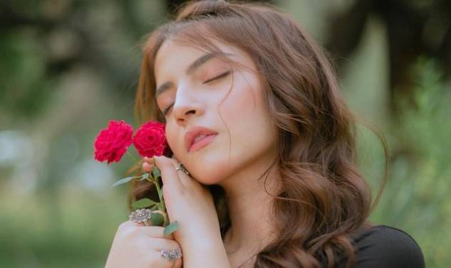 Dananeer Mobeen feeling softness of red roses 
