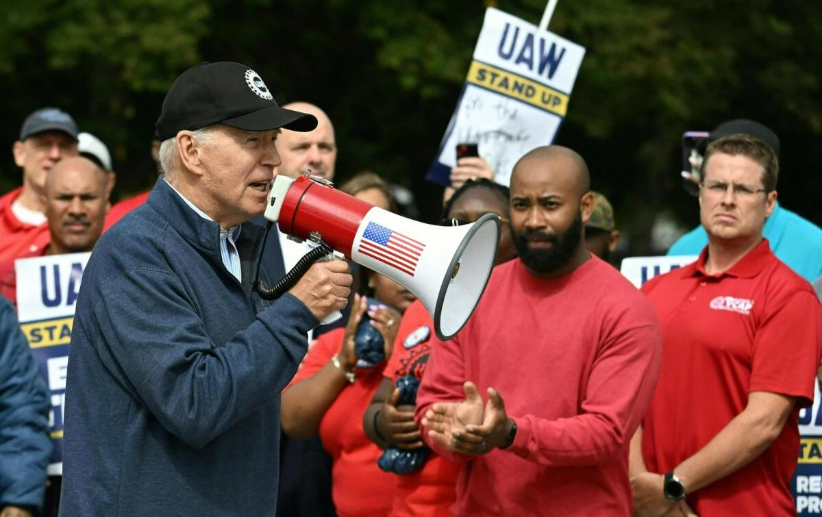 Biden makes history by joining striking US car workers
