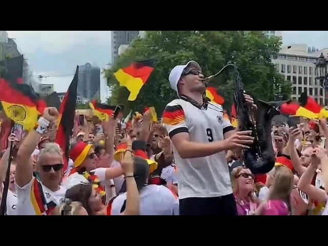 German fans dance to the tune of the 'saxophone guy'