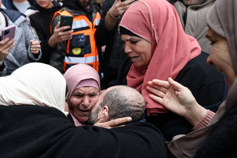 A Palestinian prisoner is embraced by family members after stepping out of a bus in the occupied West Bank city of Ramallah.–AFP