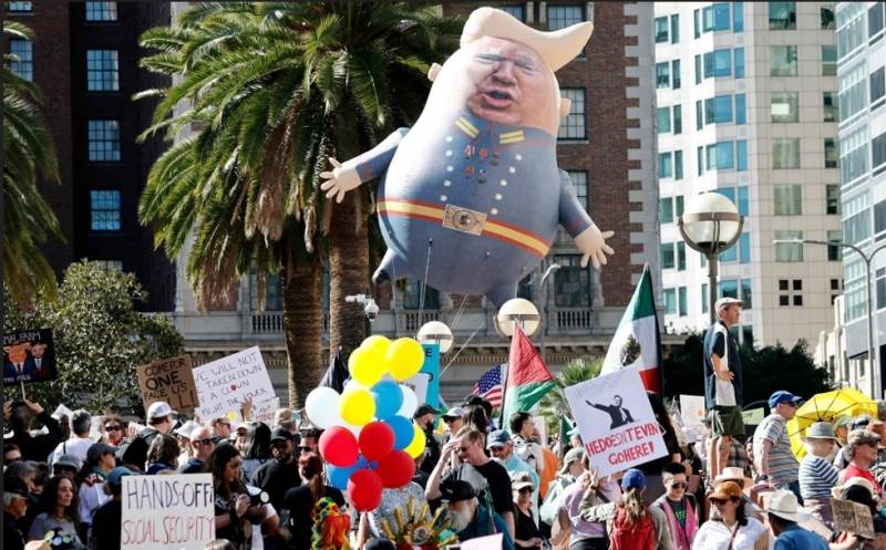 Tens of thousands march in US against Trump 'devastation'
