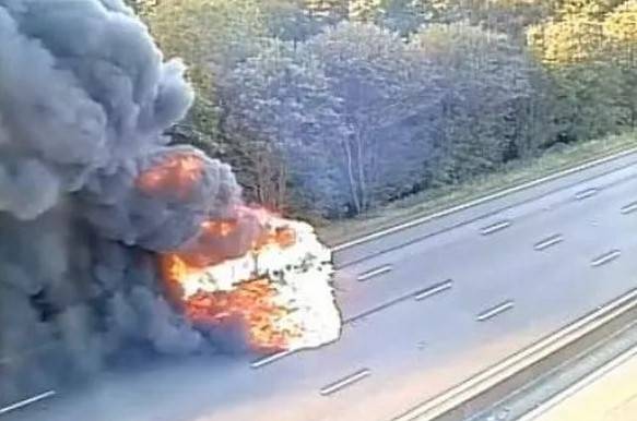 Motorway cops rescue passengers from burning van