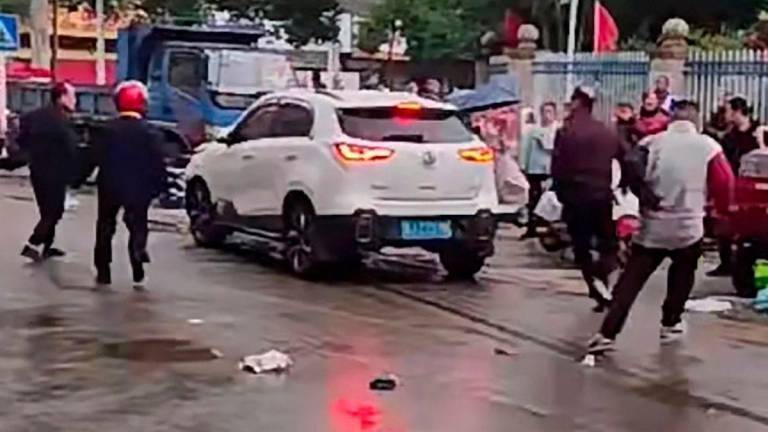 Vehicle hits pedestrians near primary school in Beijing