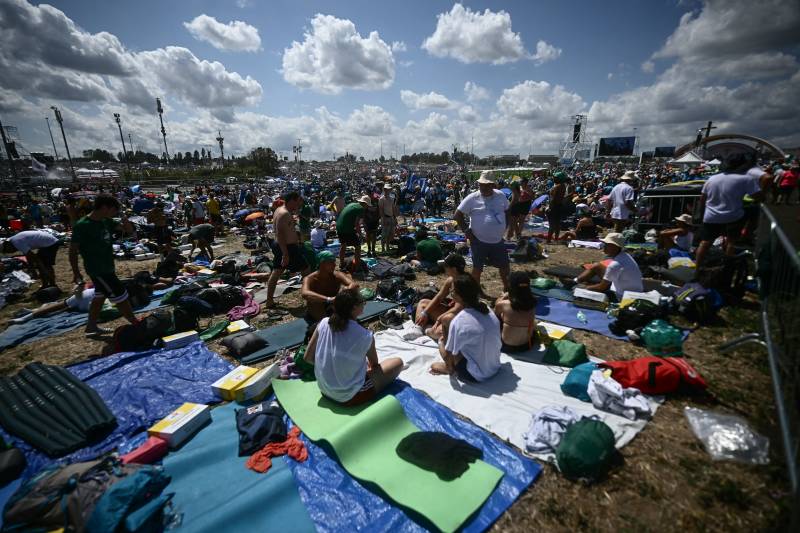 At open-air Church party, many thousands of young Catholics eagerly await pope