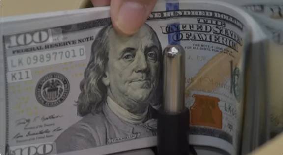 Stocks slip, dollar down as Fed meets on rates