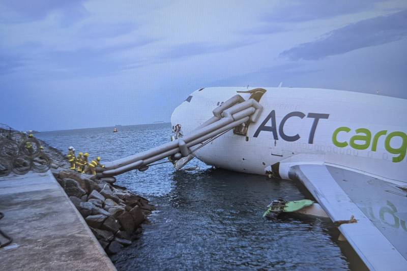 Two killed as cargo plane skids off Hong Kong runway