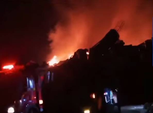 Pile of logs charred by massive fire at Karachi warehouse